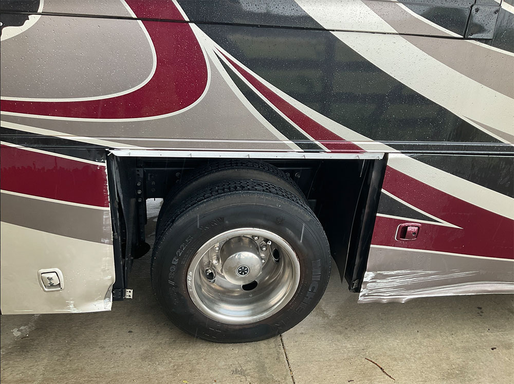 rv with damaged wheel well from collision