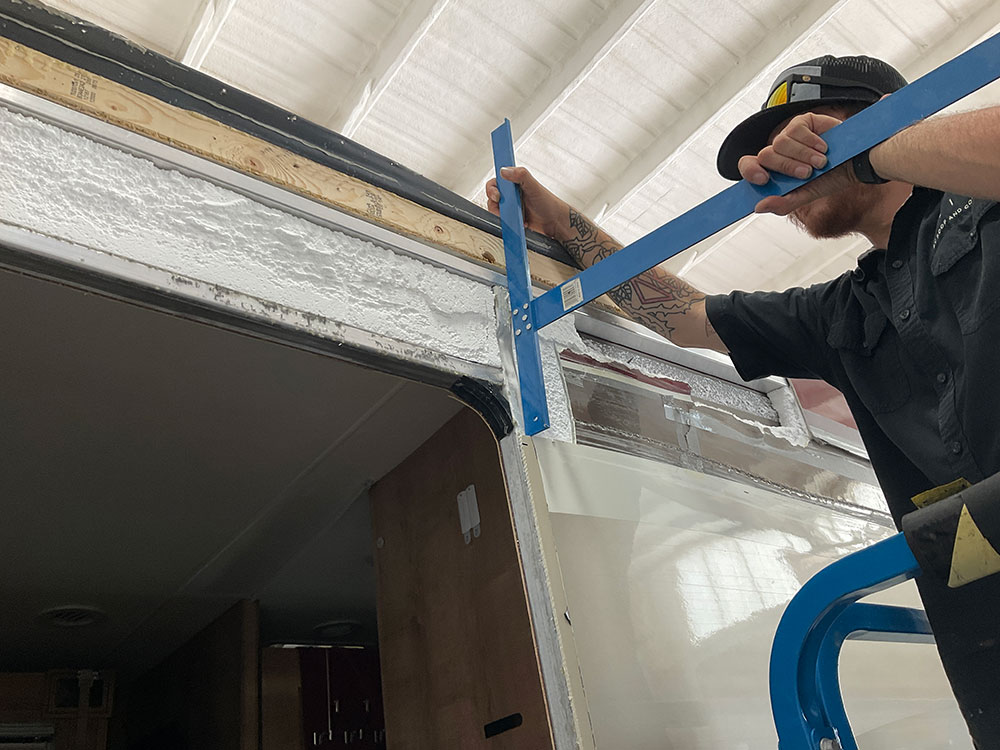 elite rv repair technician replacing insulation on rv sidewall