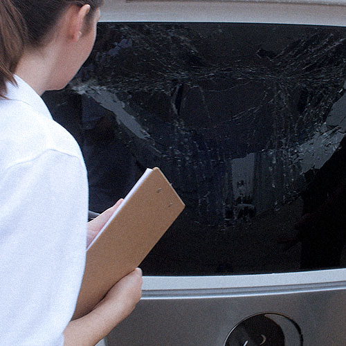 insurance adjuster inspecting rv window damage