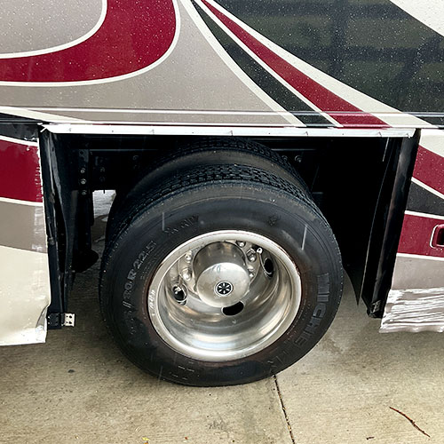 motorcoach with damage around wheel well