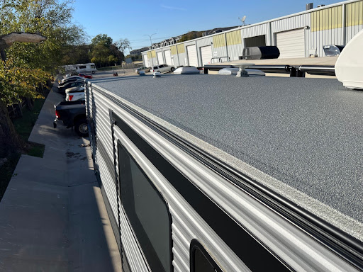 Top view of an RV with a newly installed ApexArmor spray-on roof, parked at Elite RV Roof & Collision facility with other RVs and trucks nearby.